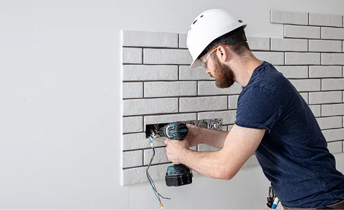 a residential electrician in Sacramento County installing new electrical wiring for electrical sockets